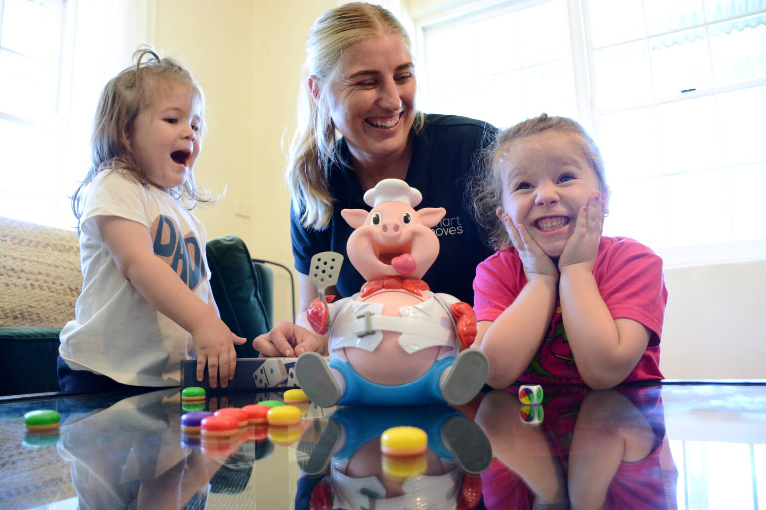 Paediatric OT playing Pop the Pig game with 2 young girls